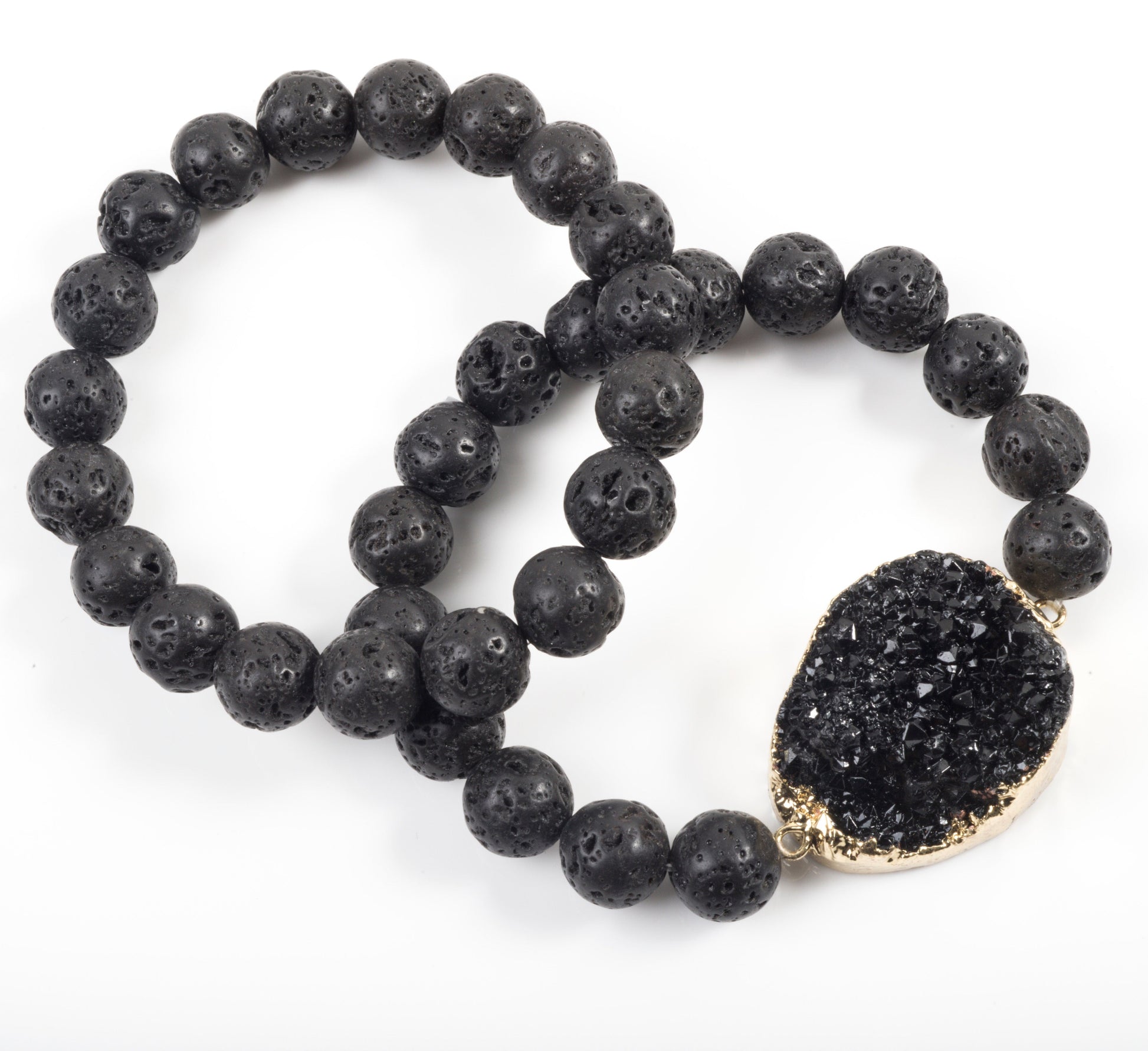Black beaded bracelet with a druzy stone charm on a white background